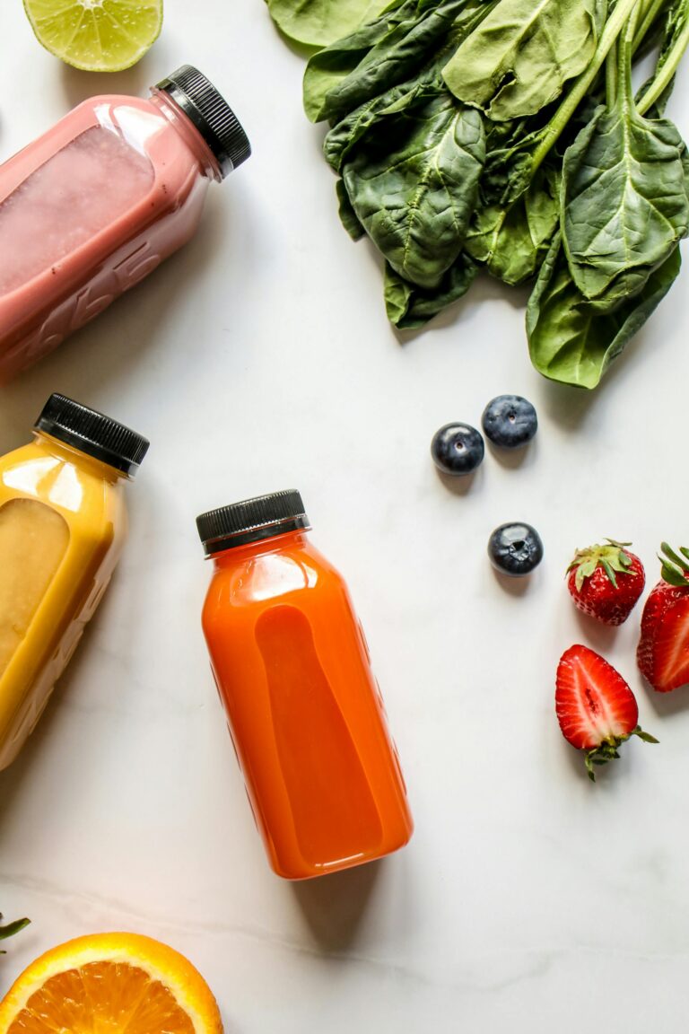 Top view of colorful juices and fresh ingredients for a healthy diet.